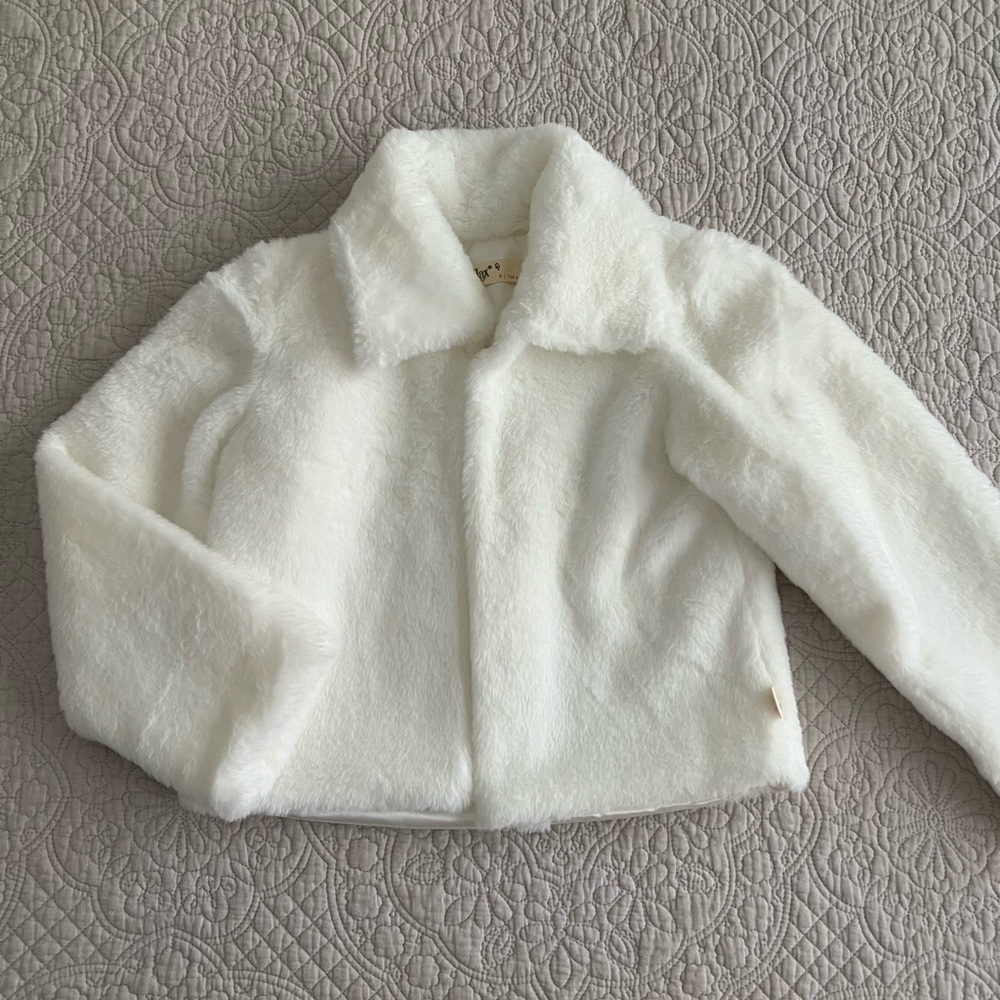 Lilax girls cozy faux fur jacket. Color is white, size 9 yrs